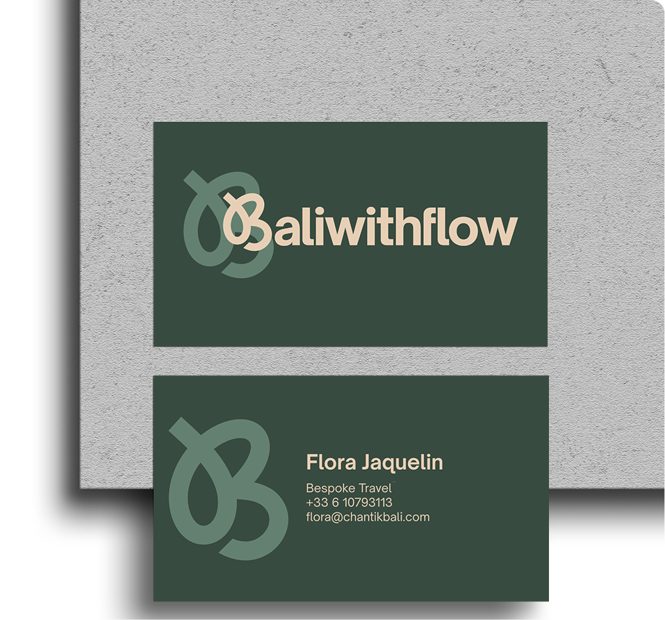 Baliwithflow business card front and back laid on textured paper showing the logo lockup and contact details