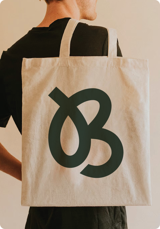 Baliwithflow branded canvas tote bag worn over the shoulder from behind