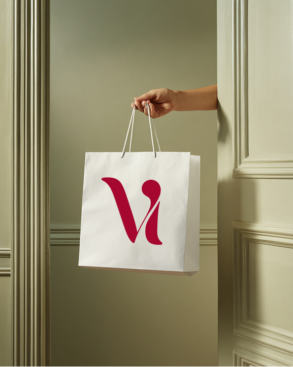 Hand carrying a white Viva Fashion shopping bag with the red V monogram